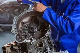 Mechanic repairing engine part with ratchet at the repair garage